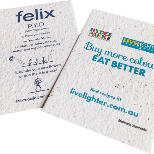 Two promotional seed paper cards. The left card explains planting instructions with a drawing of a flower. The right card reads Buy more colour. Eat better with logos and a website link, highlighting health and sustainability themes.