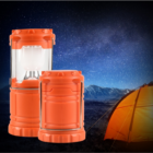 Two Promotional Pop Up LED Lanterns light up a tent under the starry night sky.