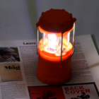 Promotional Pop Up LED Lantern glowing over a magazine page.