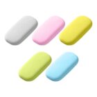 Five rectangular erasers in white, pink, yellow, green, and blue are arranged in two rows. The top row has white, pink, and yellow erasers. The bottom row has green and blue erasers. The background is plain white.
