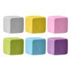 Six colorful foam cubes are arranged in two rows. The top row features gray, yellow, and pink cubes. The bottom row has light green, blue, and purple cubes. Each cube is evenly spaced against a white background.