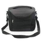 A black insulated lunch bag with a zippered front pocket, a top handle, and an adjustable shoulder strap. It also features a mesh pocket on the side for additional storage. The bag is positioned against a plain white background.