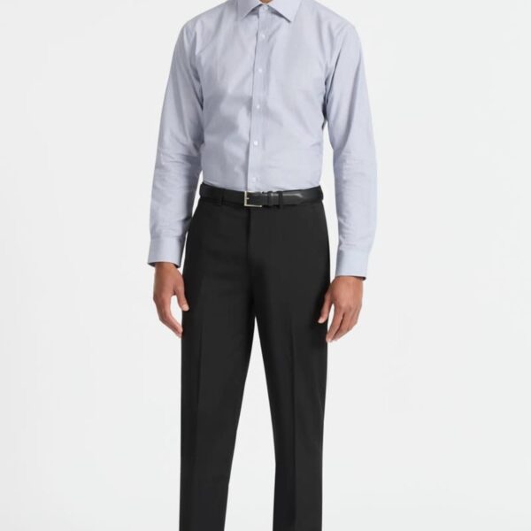 A man stands against a plain white background, wearing a light gray button-up shirt, black dress pants, and black dress shoes. He has short hair and is looking directly at the camera with a neutral expression.