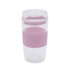 A clear plastic tumbler with a pink silicone sleeve and lid. The sleeve is wrapped around the middle of the cup, providing grip, and the lid is designed to cover the top. The tumbler is clean and stands upright on a white background.