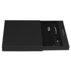 A black rectangular gift box is partially open to reveal a sleek black notebook and a matching pen inside. The items are neatly placed, giving a sophisticated and elegant presentation.