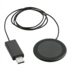 A black wireless charger with a round charging pad and an attached USB cable. The cable is coiled loosely, ending in a standard USB plug, suitable for connecting to a power source.