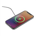 Smartphone on a wireless charger with a partially filled battery icon and 75% Charged displayed on the screen, indicating current charging status.