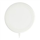 A round, white wireless charging pad with a sleek design is centered on a plain white background. A short charging cable extends from the bottom of the charger.