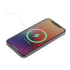 Smartphone on a white surface, displaying a battery charging screen with a green circular icon and 75% Charged text. A white charging cable is connected to the phone.