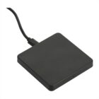 A black, square-shaped wireless charger with a connecting cable. The surface is smooth and minimalistic, and it is positioned against a plain white background.