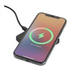 Smartphone on a wireless charging pad, showing a screen with a large green circle and a lightning bolt symbol in the center. The text 75% Charged is displayed below the circle, indicating the battery status.
