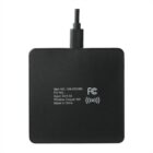 A black wireless charger with a connected USB cable. It has white text displaying item information, input, and output specifications.