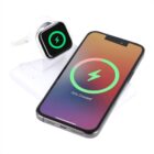 A smartphone and a smartwatch are on a wireless charging pad. The smartphone screen displays a large green battery icon with 75% Charged, and the smartwatch screen shows a similar icon, indicating it is charging.