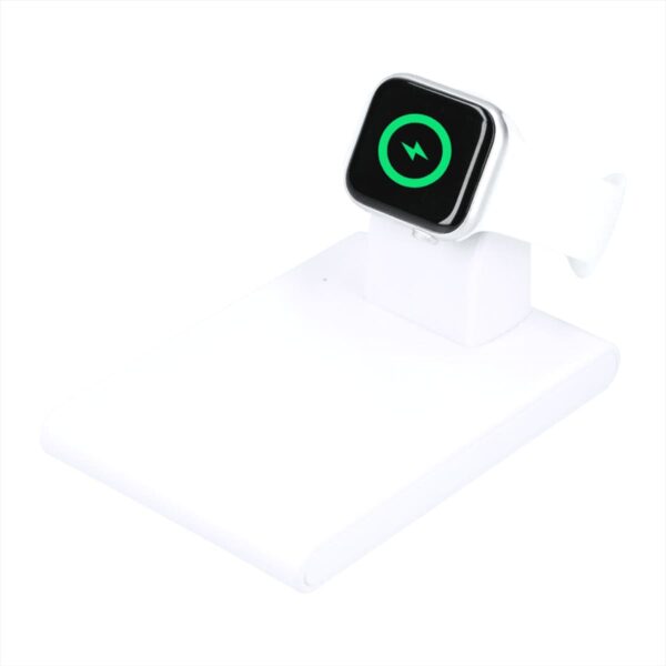 A smartwatch with a white band is displayed on a white charging stand. The smartwatch screen shows a green power symbol, indicating it is charging. The stand has a minimalist design.