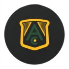 A circular emblem with a black background. It features a green letter A above a smaller green letter C, both inside a yellow shield-like design.