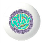 A round white container with a colorful design on the front. The design features the text Blast Soda Energy in turquoise and lime green over a background of small purple dots.