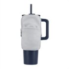 A dark blue travel mug with a lid and straw, featuring a light gray zippered pouch attached to its side handle. The pouch appears to be made of fabric and has a simple design, contrasting with the mugs modern appearance.