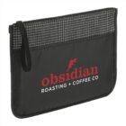Black zippered pouch with grid pattern on top and a handle. Obsidian Roasting + Coffee Co is printed in red and white on the front pocket.