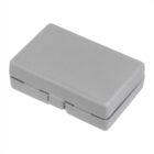 A small, closed gray plastic case with a textured surface, featuring a latch on one side for opening.