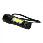 A black handheld flashlight with a wrist strap, featuring a yellow LED strip on the side.