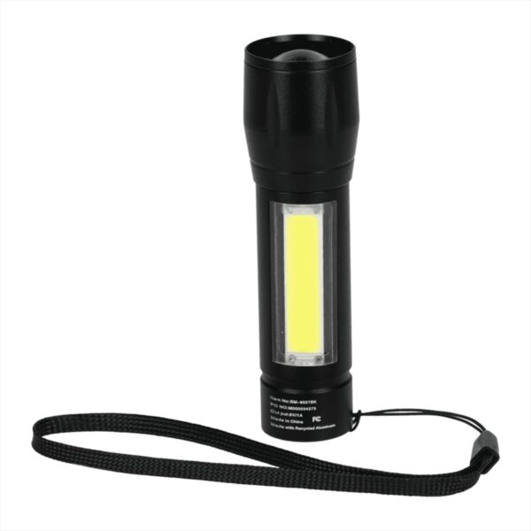 A black handheld flashlight with a strap is shown against a white background. It features a narrow cylindrical body and a yellow rectangular light panel on its side.