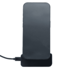 A smartphone standing upright on a wireless charging pad with a connected charging cable. The phones screen is off, and the background is plain white.
