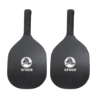 Two black pickleball paddles with the Crocs logo in white on the face. The handles are wrapped in black grips. The paddles are placed side by side against a white background.
