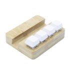 A small bamboo keyboard with four white mechanical keys on a wooden base. The design is minimalistic and compact, set against a plain white background.