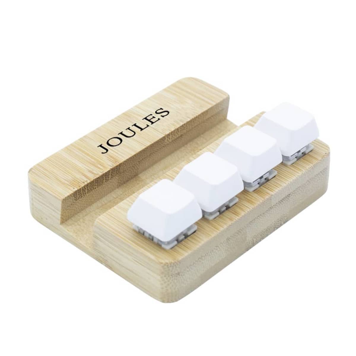 A wooden keyboard with four white keys arranged in a row on a bamboo base. The word JOULES is printed in black on the top left corner of the base.