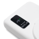 Close-up of a white power bank with a digital display. The screen shows a battery symbol at 79% and text indicating PD 22.5W, Supports SCP, QC3.0, and FCP, highlighting its charging capabilities.