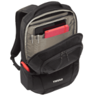 Open black Thule backpack showing compartments filled with electronic devices and a red notebook. It has multiple front pockets and a padded shoulder strap, designed for organizing and carrying various items securely.