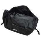 Black Thule duffel bag with a zipper partially open, showing the spacious main compartment. The bag has sturdy handles and straps, and the Thule logo is visible on the front.