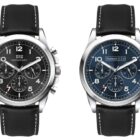 Two wristwatches with black leather straps are displayed. The left watch has a black face with white numerals and sub-dials. The right watch has a blue face with the same features. Both watches have metallic casing and chronograph designs.