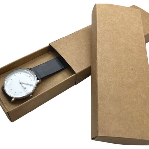 A minimalist wristwatch with a white face and black strap is shown partially out of a brown cardboard box. The box is open and positioned diagonally.