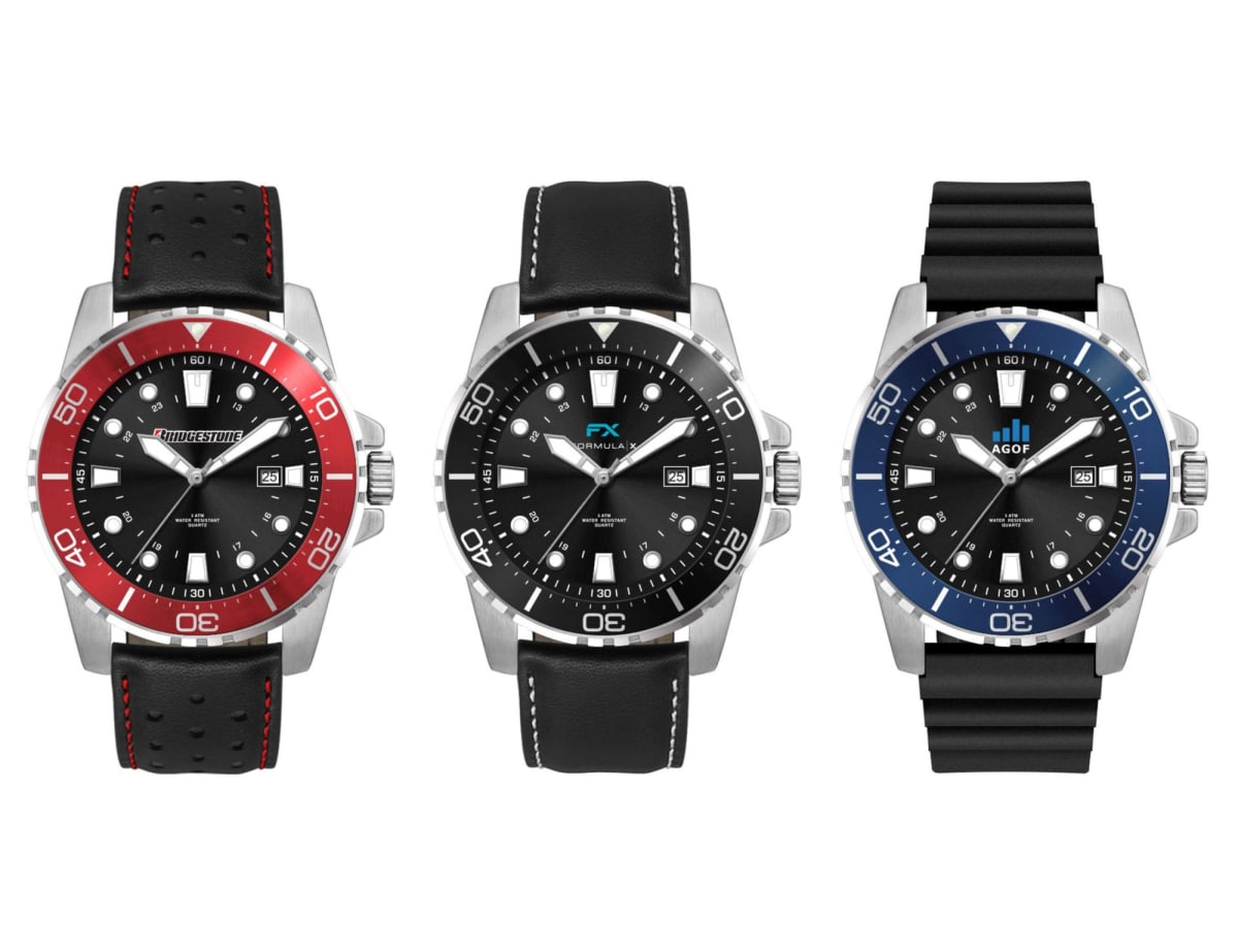 Three diver watches are displayed side by side. The first has a red and black bezel with a perforated strap, the second a black bezel with a smooth strap, and the third a blue and black bezel with a ribbed strap. All feature date displays.