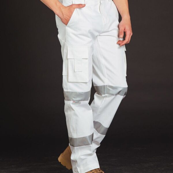 Person wearing white cargo pants with reflective stripes and tan work boots, standing against a dark background. Hands are in pockets, and the upper body is not visible.