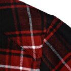 Close-up of a red and black plaid fabric with white lines, showing a pocket detail. The pattern consists of intersecting horizontal and vertical stripes, creating a traditional tartan look.