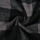 Close-up of a plaid fabric with a swirling pattern. The fabric features various shades of gray and black, creating a checkered design. The texture appears soft and the pattern converges at the center.
