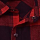 Close-up image of a red and black plaid shirt with black buttons and snap closures. The label inside reads Style No. WT11.