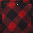 Close-up of a red and black plaid fabric with a pocket. The pattern features large squares, and the pocket is fastened with a single black button.