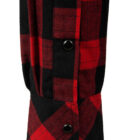Close-up of a red and black plaid flannel shirt sleeve with two black buttons on the cuff.