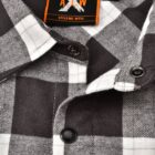 Close-up of a black and white checkered flannel shirt with black buttons. The label inside the shirt reads A X W and Style No. WT11 in orange and white.