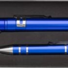 A boxed set containing a blue flashlight and a blue pen with silver accents, placed in black foam packaging. The flashlight is positioned above the pen.