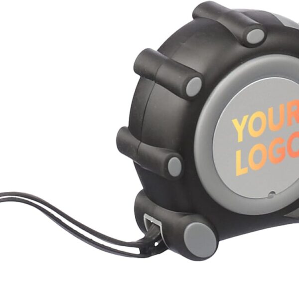 The Ramos MeasureMate tape, in black and gray, offers a YOUR LOGO area with vibrant orange and yellow text for customization. Its compact, ergonomic design and included strap ensure easy carrying and convenience.