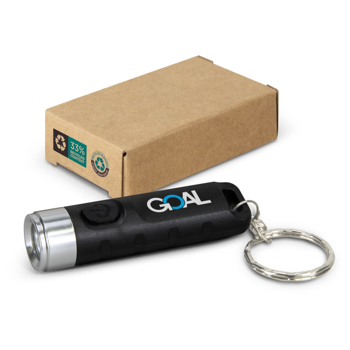 Small black flashlight keychain labeled GOAL with cardboard box in background.