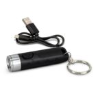 Black keychain flashlight with a silver rim and a USB charging cable beside it.