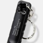 Black device with a metal keyring, USB-C port, and white technical specs printed on it.