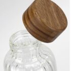 Clear glass jar with a wide mouth and a round wooden lid, shown against a white background.