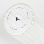 The bottom of a clear glass cup with care instructions and capacity printed in black text.