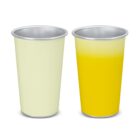 Two metal cups, one with a white drink and one with a yellow drink, on a white background.